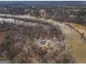 An aerial view shows a lake home tucked among trees with river access and neighboring lake houses at 650 Malcom Rd, Covington, GA 30014