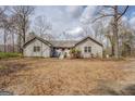 Inviting single-story home featuring a light gray exterior with a wooden bridge leading up to the front entrance at 650 Malcom Rd, Covington, GA 30014