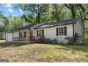 Charming single-story home with flowering bushes in the front and white painted siding at 1620 Summit Rdg, Auburn, GA 30011