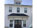 Close-up of modern townhome with black metal roof over entrance and dormer windows at 1848 Eastmore Ave, Conyers, GA 30094