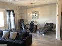 Open concept living space with modern decor, stylish furniture, and hardwood floors at 1848 Eastmore Ave, Conyers, GA 30094