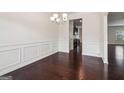 Elegant dining room featuring dark hardwood floors and wainscoting at 903 Hollytree Pl, Acworth, GA 30102