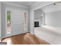 Inviting foyer with hardwood floors, complemented by a bright living space featuring a fireplace and arched window at 1300 Lakehaven Pkwy, Mcdonough, GA 30253