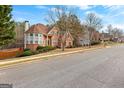 Traditional brick home with a bay window and manicured landscaping in a suburban neighborhood at 510 Virginia Highlands, Fayetteville, GA 30215