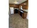Functional kitchen with ample cabinet space, black appliances, and a double basin sink at 220 Cabriolet Trl, Mcdonough, GA 30253