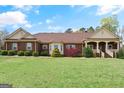 Charming one-story brick home with well-manicured lawn and tasteful landscaping at 7395 Old Rico Rd., Chattahoochee Hills, GA 30268