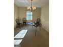 Cozy dining room with a chandelier and view of the yard through the window at 2518 Caladium Ne Dr, Atlanta, GA 30345