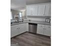 Kitchen showcasing stainless steel dishwasher, sink, and ample cabinet space at 1105 Bradford Park Dr, Auburn, GA 30011
