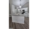 Open-concept kitchen with island, granite countertops, and modern pendant lighting at 1105 Bradford Park Dr, Auburn, GA 30011