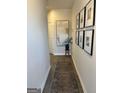 Inviting hallway adorned with stylish artwork and a decorative rug, creating a warm and welcoming entrance at 11523 Kimberly Way # 6, Hampton, GA 30228