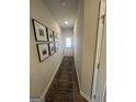Entry hallway with wood-look flooring, neutral walls and decorative art pieces at 11551 Kimberly Way # 17, Hampton, GA 30228