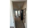 Upstairs hallway with carpet flooring leads to bedrooms; artwork adorns the walls at 11551 Kimberly Way # 17, Hampton, GA 30228