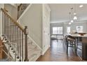 Inviting entryway with staircase leading to a bright, open-concept kitchen and dining area at 130 Brooks Cir, Hampton, GA 30228