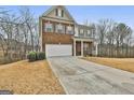Attractive two-story home with brick and siding exterior, complemented by a well-manicured lawn at 130 Brooks Cir, Hampton, GA 30228