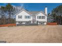 Inviting two-story home featuring a welcoming front porch and lush surroundings at 31 Pecan Lake Ct, Sharpsburg, GA 30277