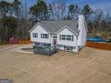 Two-story house with deck, lawn, and a glimpse of a backyard pool at 31 Pecan Lake Ct, Sharpsburg, GA 30277