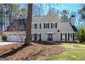 Traditional two-story home featuring a manicured lawn, two-car garage, and charming facade with black shutters at 339 Kensington Dr, Peachtree City, GA 30269
