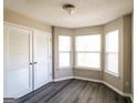 Sunny bedroom boasts new gray flooring, ample natural light with a nice bay window, and a closet at 5345 Bridle Point Pkwy, Snellville, GA 30039