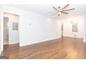 Open-concept living area with hardwood flooring and a modern ceiling fan, perfect for entertaining at 623 Montevista Sw St, Atlanta, GA 30310