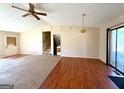 Open living area with hardwood and carpet flooring, a ceiling fan, and sliding glass doors at 4617 Palm Dr, Douglasville, GA 30135