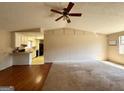 Open living area with hardwood and carpet flooring and a ceiling fan at 4617 Palm Dr, Douglasville, GA 30135
