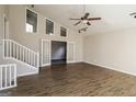 Open living room with stairs, french doors, vaulted ceilings, and new wood-look flooring at 6290 Shallowford Way, Douglasville, GA 30135