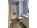 Cozy bathroom featuring wood-look floors, toilet, and a single-sink vanity at 254 Olde Oaks Ln, Riverdale, GA 30274