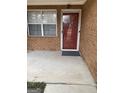 Exterior front door with a brick wall and a Welcome mat at 254 Olde Oaks Ln, Riverdale, GA 30274