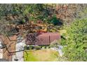 Aerial view of property showcasing home, beautiful landscaping, and spacious wooded lot with private back deck at 9491 Hidden Branch Dr, Jonesboro, GA 30236