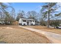 Charming two-story home with a neatly landscaped front yard and driveway at 1276 Pineglen Dr, Riverdale, GA 30296