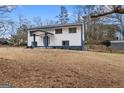 Charming two-story home with a neatly landscaped front yard and driveway at 1276 Pineglen Dr, Riverdale, GA 30296