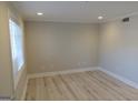 Bright, empty bedroom with neutral walls, ample natural light from the window, and stylish wood-look flooring at 117 Rondak Se Cir, Smyrna, GA 30080