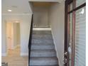 Inviting entryway featuring a carpeted staircase, leading to the upper level, and adjacent hardwood flooring at 117 Rondak Se Cir, Smyrna, GA 30080