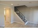 Attractive staircase featuring carpeted steps, modern railings, neutral wall colors, and hardwood floors at 117 Rondak Se Cir, Smyrna, GA 30080
