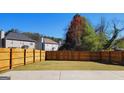 Picture of a spacious backyard with full fencing with mature trees along the border at 7926 Palomino Pass, Riverdale, GA 30274
