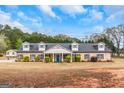 Charming one-story home with a welcoming front porch, manicured lawn, and dormer windows at 1500 Highway 155 North, Mcdonough, GA 30252