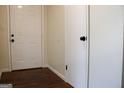 Bright hallway featuring hardwood floors, white doors, and neutral paint creating a welcoming space at 3647 Glen Mora Dr, Decatur, GA 30032