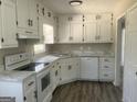 The kitchen has white cabinets, modern countertops, and essential appliances for convenient meal preparation at 3953 Woodland Se Cir, Conyers, GA 30013