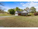 A charming single-story brick house sits on a spacious lot with a lush green lawn at 628 Morningside Dr, Stockbridge, GA 30281