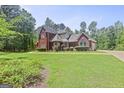 Beautiful brick home with lush greenery and a well-maintained lawn at 643 Old Greenville Rd, Fayetteville, GA 30215