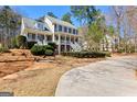 Beautiful two-story home with a double porch, gray exterior, and well-manicured lawn at 300 Tarragon Dr, Fayetteville, GA 30215