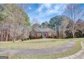 Inviting home with a well-maintained lawn, brick accents, and a neatly landscaped front yard at 140 Rockglen Ct, Fayetteville, GA 30215