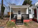 Inviting covered porch with black railing and trim, offering a cozy outdoor space at 1165 Fair Sw St, Atlanta, GA 30314