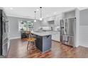 Bright kitchen featuring a large island, stainless steel appliances, wood flooring, and ample counter space at 880 Brooks Woolsey Rd, Brooks, GA 30205
