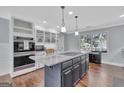 Stylish kitchen showcasing a granite island, stainless steel appliances, and custom cabinetry at 880 Brooks Woolsey Rd, Brooks, GA 30205