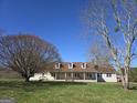Inviting ranch-style home with a covered front porch,dormer windows, and surrounded by beautiful mature trees at 1761 Reavesville Rd, Bowdon, GA 30108
