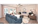 Inviting living room with a cozy fireplace, neutral colors, and an array of stylish furnishings at 10414 Trellis Lane (Lot 36), Hampton, GA 30228