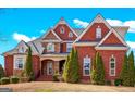 Beautiful red brick home with stone accents and manicured front yard landscaping at 560 Birkdale Dr, Fayetteville, GA 30215