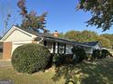 Side view of a house with a brick and siding exterior and manicured bushes at 4634 Bexley Dr, Stone Mountain, GA 30083