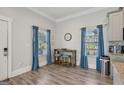 Bright dining area with wood floors, blue curtains, and a small table set for two at 906 Sims Sw St, Atlanta, GA 30310